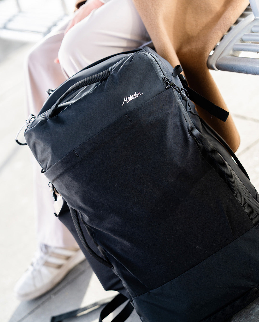 A durable one-bag on the ground outside a train station