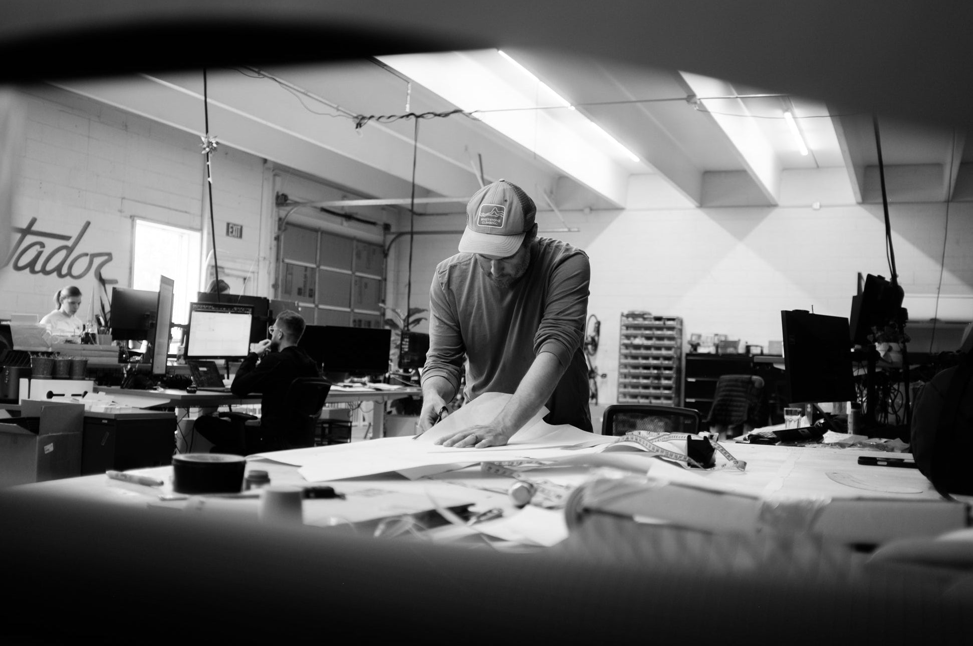 man cutting paper at workbench