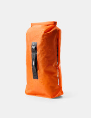 orange dry bag with water droplets on white background