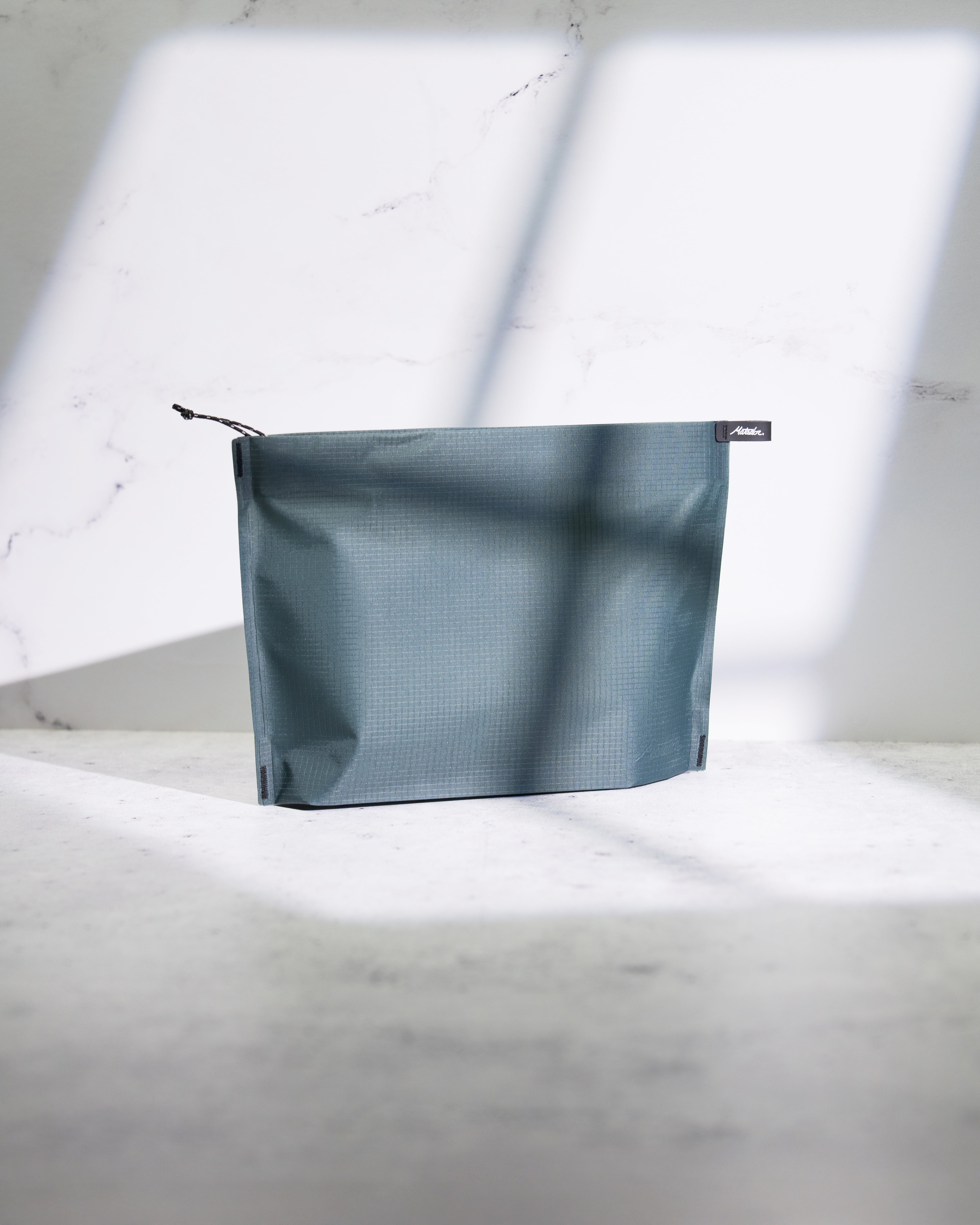 Juniper zipper toiletry case on a light gray background