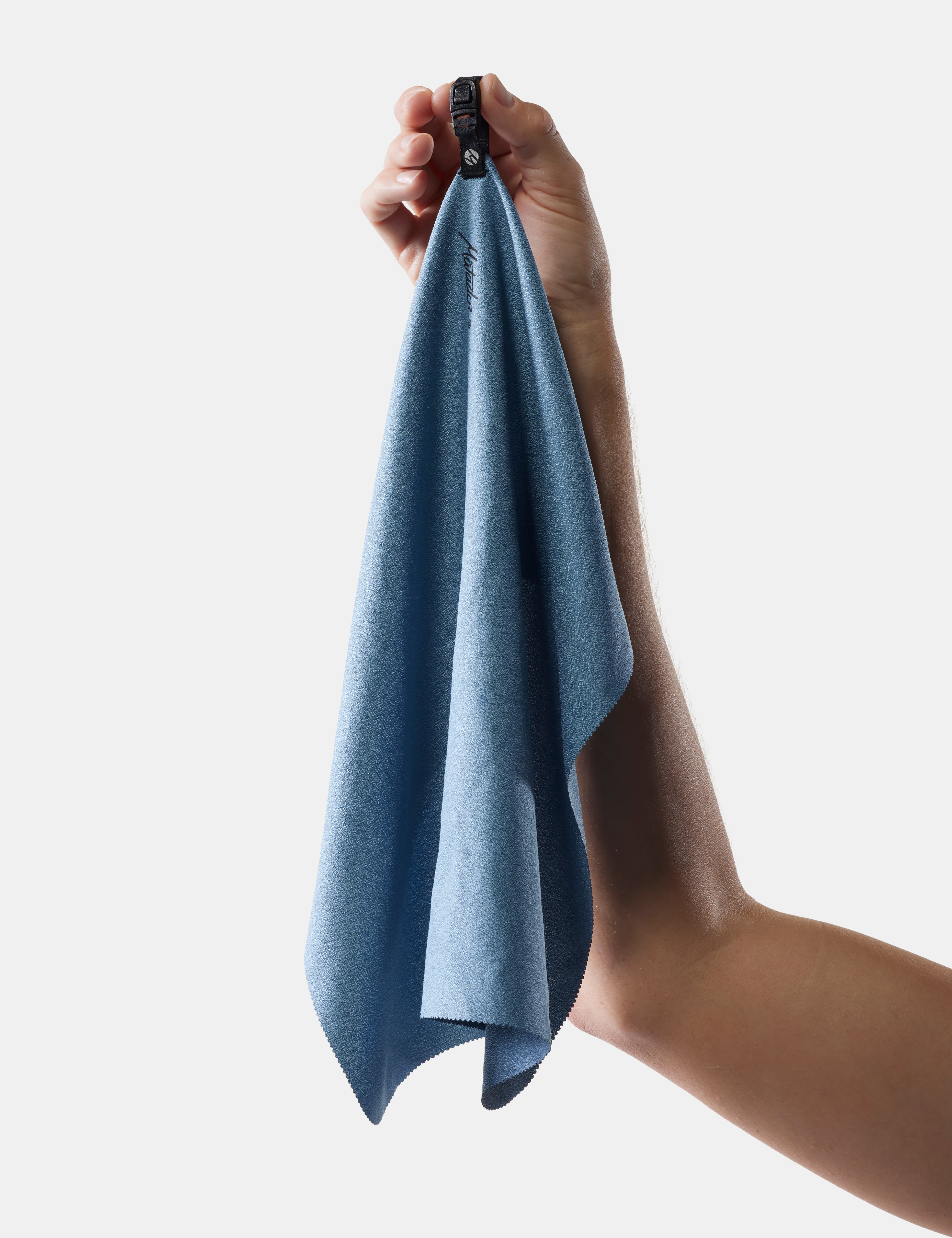 Hand holding a slate towel against a light gray background