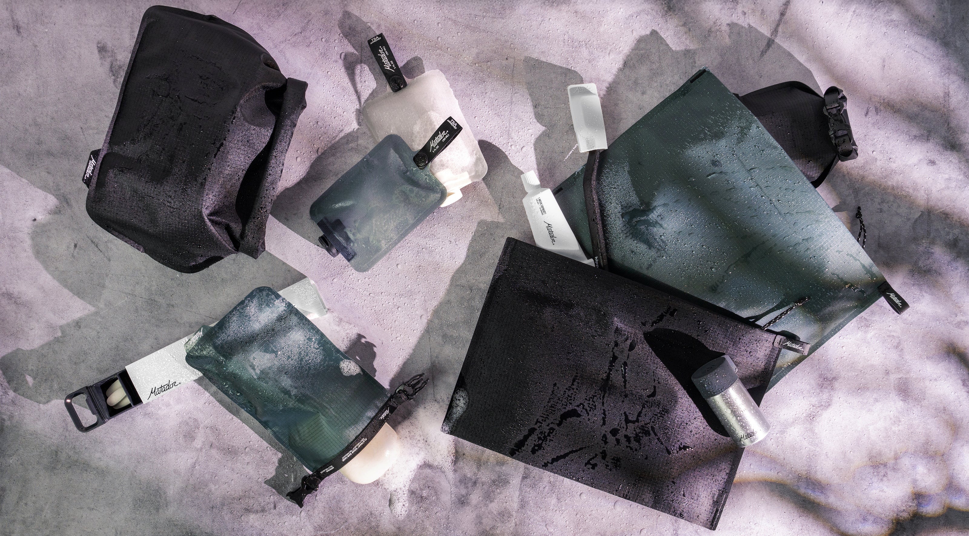 travel toiletry cases laying on a counter top