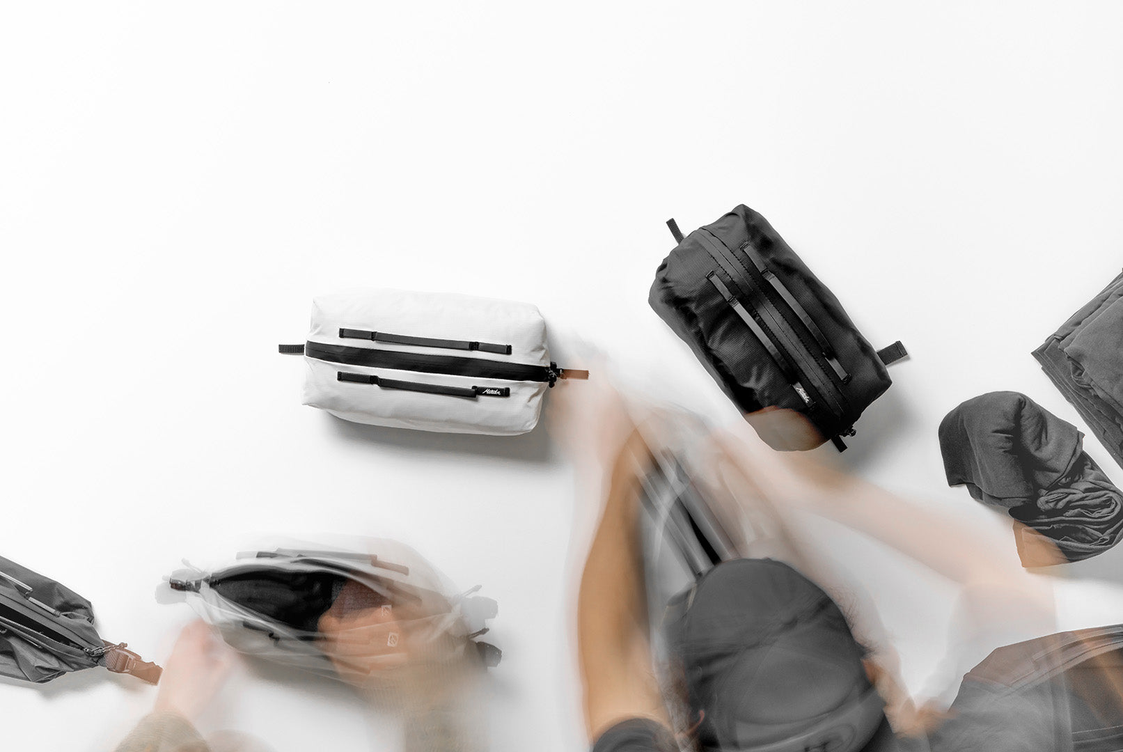 Collection of compression packing cubes for international travel gear on a white surface