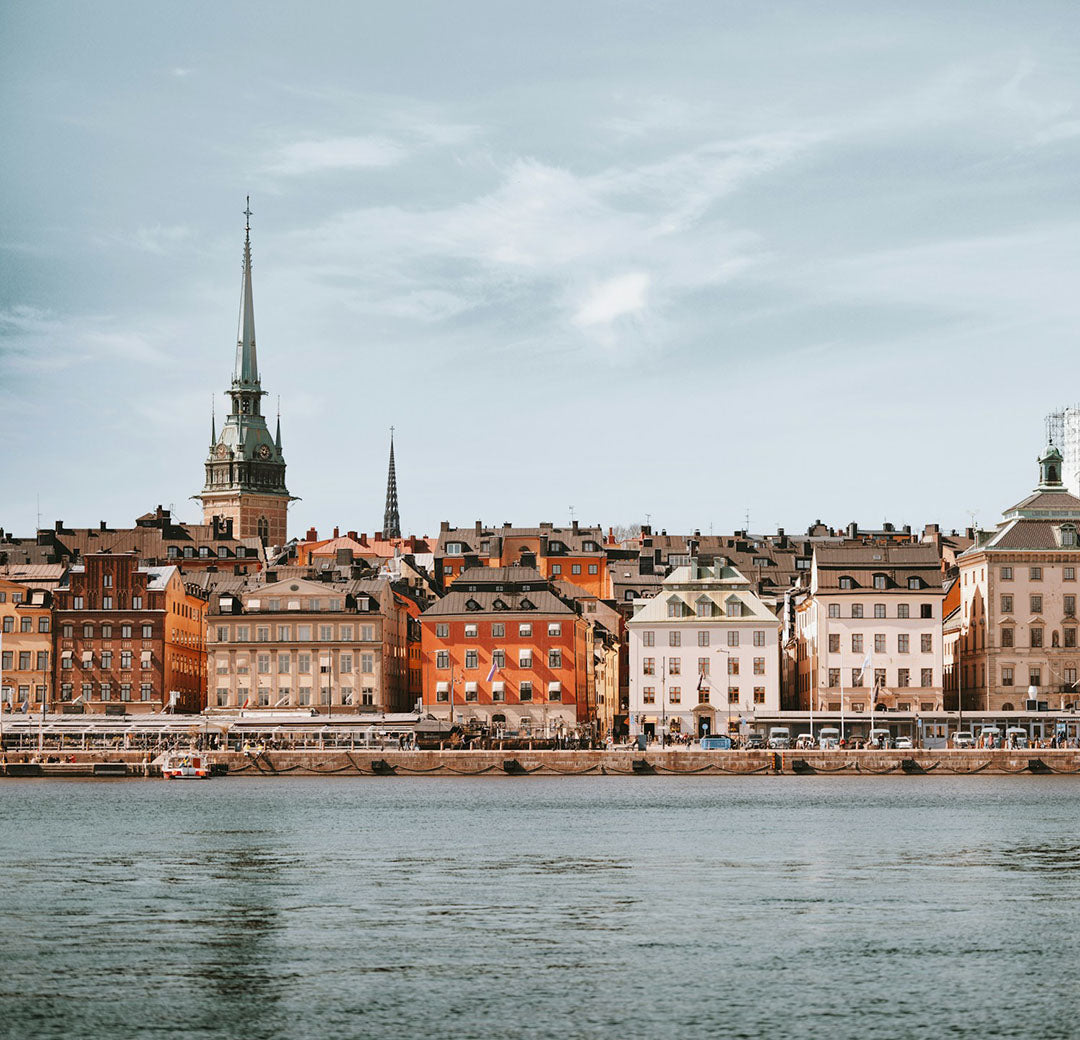Cityscape with historic buildings along a waterfront on a clear day